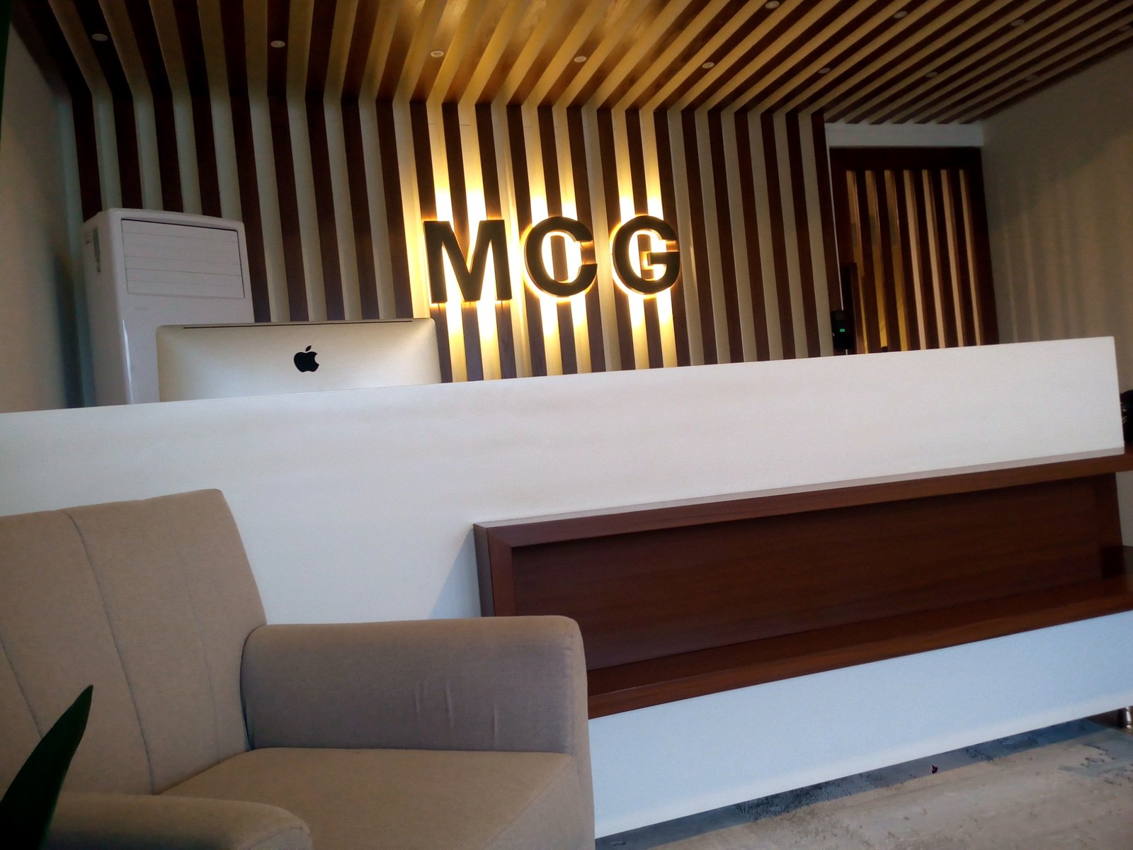 MCG reception wall signage with warm halo lighting